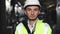 Portrait of a frontline essential worker in a warehouse. Caucasian business people in hard hat or safety wear
