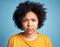 Portrait, frown and anger with an african woman on a blue background in studio looking mad or serious. Face, bad or