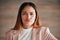 Portrait, frown and business woman in office confused, unsure or unhappy on wall background. Face, sad and angry