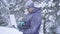 Portrait frozen man in winter forest uses laptop