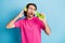 Portrait of funky guy holding device like mic listening singing pop single having fun isolated over bright blue color