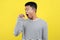 Portrait of funny Asian man yawning covering open mouth and showing a sleepy gesture. feeling being tired from hard work, isolated