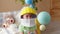 Portrait of funny baby boy in an astronaut helmet with a baby rocket and a planet playing flying in the nursery. Happy