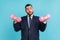 Portrait of funny bearded businessman wearing official style suit, holding in hands pink heavy