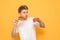 Portrait of a funny boy with two pieces of pizza in his hands on a yellow background. Hungry guy with pizza in his hands is