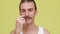 Portrait of funny caucasian man smiling over yellow background making face while twirling mustaches closeup. Concept of