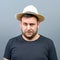 Portrait of funny chubby man wearing straw hat