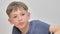 Portrait of funny and excited school boy on white background smiling and eating popcorn from a bowl