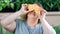 Portrait of funny fat dieting woman posing with half orange covering eyes medium close-up