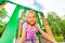 Portrait of funny girl on playground chute