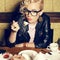 Portrait of funny hipster blonde girl eating cake