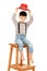 Portrait of a funny little boy sitting on a high stool in a red