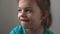 Portrait Funny little close up view happy preschool girl smiling child looking away thoughtfully, pretty natural face