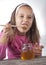 Portrait of funny lovely little girl eat honey