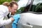 Portrait of funny man washing car