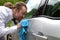 Portrait of funny man washing car