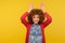 Portrait of funny positive playful woman with fluffy curly hair making bunny ears gesture, having fun