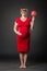 Portrait of funny pregnant woman in red dress