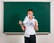 Portrait of funny pupil. School boy very emotional, having fun and very happy, blackboard background - back to school and