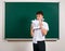 Portrait of funny pupil. School boy very emotional, having fun and very happy, blackboard background - back to school and