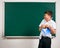 Portrait of funny pupil. School boy very emotional, having fun and very happy, blackboard background - back to school and