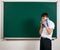 Portrait of funny pupil. School boy very emotional, having fun and very happy, blackboard background - back to school and