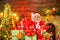 Portrait of funny Santa man indoors with Christmas gift. Bearded man having fun near Christmas tree indoors.