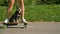 PORTRAIT: Funny shot of a puppy riding an e-longboard with fit young woman.