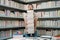 Portrait of funny teacher with book in library classroom. Handsome teacher in university library. Funny teacher hold