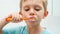 Portrait of funny toddler boy cleaning and brushing teeth at morning. Concept of teeth hygiene and child healthcare