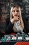 Portrait of gambling lucky woman playing poker with card and chips at casino