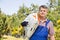 Portrait of gardener carrying sack in plant nursery