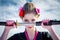 Portrait of geisha holding katana in black and pink kimomo on blue cloudy sky background