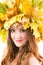 Portrait of girl with autumn wreath of maple leave