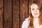 Portrait of girl on background wooden wall