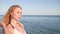 Portrait girl on beach, looks into distance, beautiful women, wind