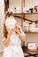 Portrait of a girl in a beauty parlor. a woman hides, covered her face with a plaster mask, vertical image