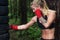 Portrait of girl boxer doing uppercut kick working out outdoors.