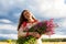 Portrait of a girl with a bunch of willow-herb in a green field