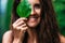 Portrait of a girl in close-up. Beautiful smile. Portrait of a beautiful smiling girl. Portrait of a girl with a green leaf.