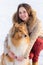 Portrait of girl with collie dog on snow landscape