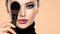 Portrait of a girl with cosmetic brush at face. Woman covering one eye on the face using makeup brush. One half face of a