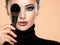 Portrait of a girl with cosmetic brush at face. Woman covering one eye on the face using makeup brush. One half face of a