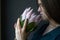 Portrait of a girl with dark hair holds a pink huge protea, selective focus