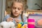 Portrait of girl enthusiastically engaged in knitting