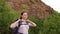 Portrait of girl hiker with backpack on mountain.