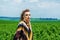 Portrait of a girl with makeup Amazon, Viking, aggressive war paint. Dressed in a poncho on the background sky, green field