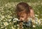 Portrait of a girl in the middle of a chamomile field