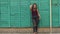 Portrait of a girl model plus size on the background of a green wall.