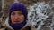 Portrait of a girl near a mountain stream in winter forest. Close-up